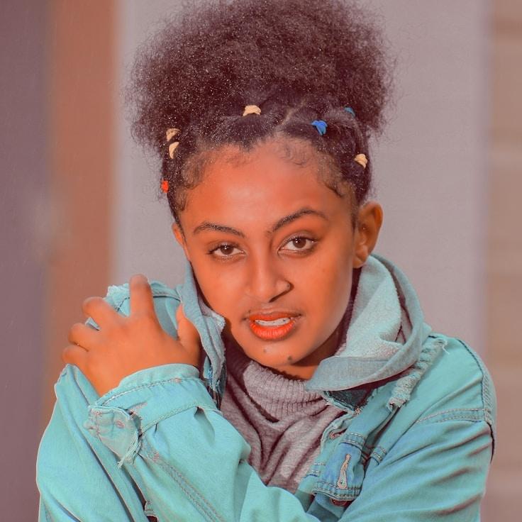 ALEX MORGAN, Lead Design Curator at CalmHarborCrest, reviewing corporate floral arrangements